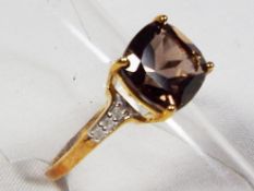 A lady's 9 carat gold diamond set smoky quartz ring, size P & 1/2, approx. weight 2.