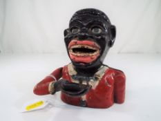 An original mechanical Money Bank in the style of a black man, 15.