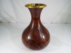 A substantial cloisonne bulbous vase with everted rim decorated in a floral design,