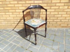 An antique slat back corner chair with upholstered seat.