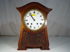 A good Art Nouveau oak cased mantel clock, the case having incised and carved decoration,