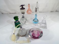 A collection of eight good quality perfume bottles of varying shapes,