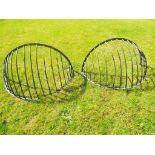 A pair of early period cast iron wall mounted hay or straw horse feeders,