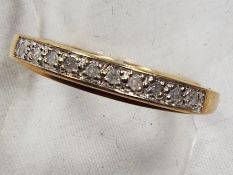 A lady's 9 carat gold .10 pt diamond set half eternity ring, size_, approx weight 2.