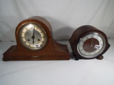 An oak cased mantle clock with pendulum and a further oak cased mantle clock with pendulum and key