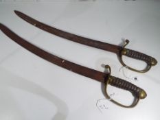 Two 18th century British Naval boarding short sabres with chagrin wired grip and brass hand guards,