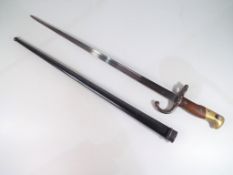 A 19th century French bayonet and steel scabbard,