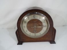 A Enfield oak cased mantel clock, Arabic numerals on a silvered chapter ring,