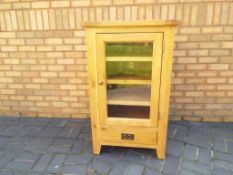 A good quality beech glass fronted cabinet,