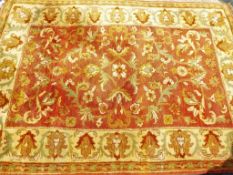 An Indian wool rug in gold and brown tones,