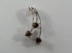 A lady's hallmarked 9ct white gold and three citrine stone set pendant, approx. weight 1.