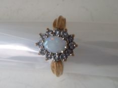A lady's hallmarked 9 carat gold opal and cz cluster ring, approximate weight 3.