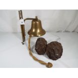 A good quality heavy wall mounted brass bell and a pair of brass wall mounted lion heads inscribed