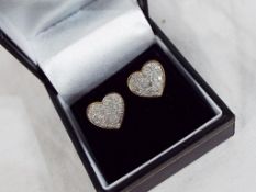 A pair of 9 carat gold stud earrings set with 50 pt 1/2 ct diamond cluster, heart shaped,