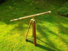 A brass telescope on tripod support, a set on kitchen scales with graduated weights,