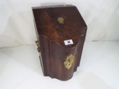 A Georgian mahogany cutlery box with serpentine outline,