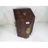 A Georgian mahogany cutlery box with serpentine outline,
