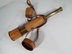 A brass telescope by Kelvin and Hughes in leather case.