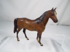 A cold painted bronze study of an unbridled standing horse, height 18.