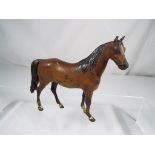 A cold painted bronze study of an unbridled standing horse, height 18.