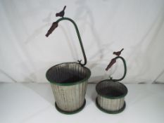 Two round metal planters.