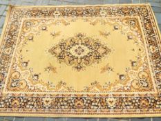 A good quality floor rug decorated in tan and brown approximately 225 cm x 160 cm
