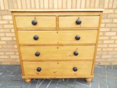 A late 19th century pine chest of drawers two over three with original bun handles,