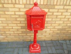 An original Huntley cast iron red post box / pillar box, with operational lock and two keys,