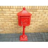 An original Huntley cast iron red post box / pillar box, with operational lock and two keys,
