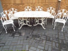 A wrought iron garden table with six matching chairs,