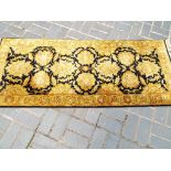 A rectangular Indian wool rug gold and n