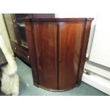 A Georgian mahogany corner cupboard of b