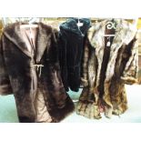 Three fur coats, one in brown approximat