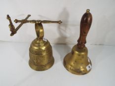 2 brass bells, 1 decorated in relief. (2