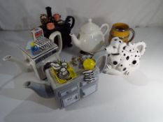 Five novelty teapots, one in the form of