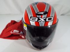 A motorcycle helmet by Axo with cover