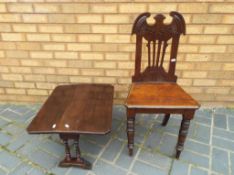 A highly carved good quality oak occasional chair and an oak drop leaf occasional table,