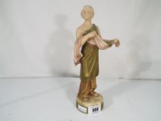 Royal Dux - A ceramic figurine by Royal Dux depicting a lady in the Classical style,