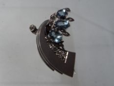 A lady's hallmarked 9 carat white gold hand-made pin-back brooch set with aquamarines and diamonds,