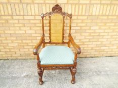 A highly carved oak chair, upholstered.