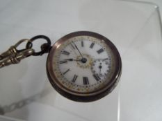 A lady's silver pocket watch with Roman numerals on a white dial, marked 935, serial No.