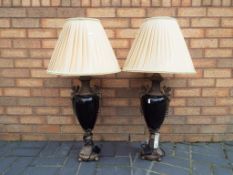 A pair of good quality brass and ceramic table lamps with champagne coloured pleated lamp shades,