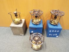 4 vintage paraffin stoves, 3 contained in metal cases,