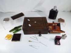 A wooden inlaid jewellery box containing a manicure set and similar.