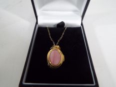 A lady's 9 carat gold mother of pearl oval locket, approx 2.