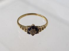 A lady's 9 carat gold stone set cluster ring set with a diamond surrounded by six sapphire,