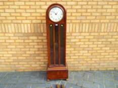 A 1920's grandmother clock with arch top, circular dial marked R.