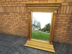 A large gilt framed bevel edged over wall mirror, overall size 138 cm x 104 cm.