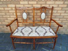 An Edwardian mahogany framed two-seater salon settee / sofa - Est £80 - £120