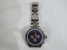 A gentleman's chronograph with metal strap, blue dial marked "Breitling".
